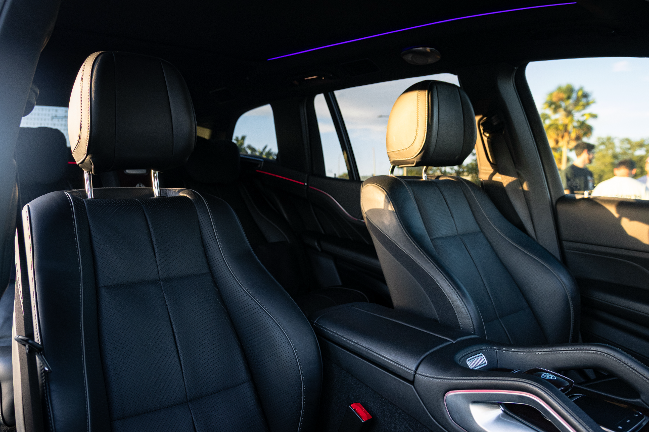Alt text: "Luxury black leather car seats featuring ergonomic design and ambient lighting, perfect for enhancing comfort and style in high-end vehicles."