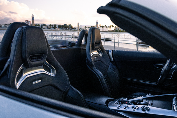Car interior with a focus on the steering wheel and dashboard.